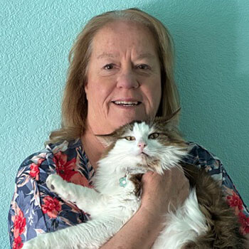 Cat sitter giving her fluffy kitty a hug.