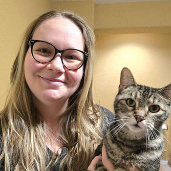 Kitty sitter and her curious cat are smiling for the camera and ready to take care of your pet.